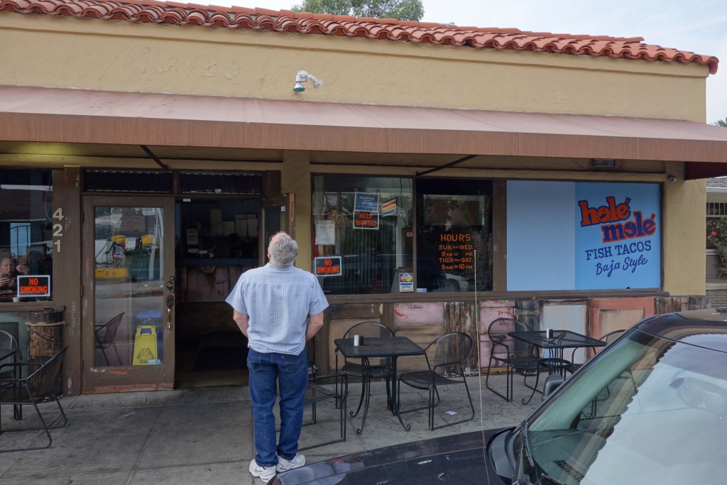 My uncle checking out Holé Molé on Obispo. He used to live in the apartment in back of the restaurant.